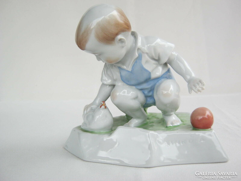 Little boy stroking Zsolnay porcelain hen