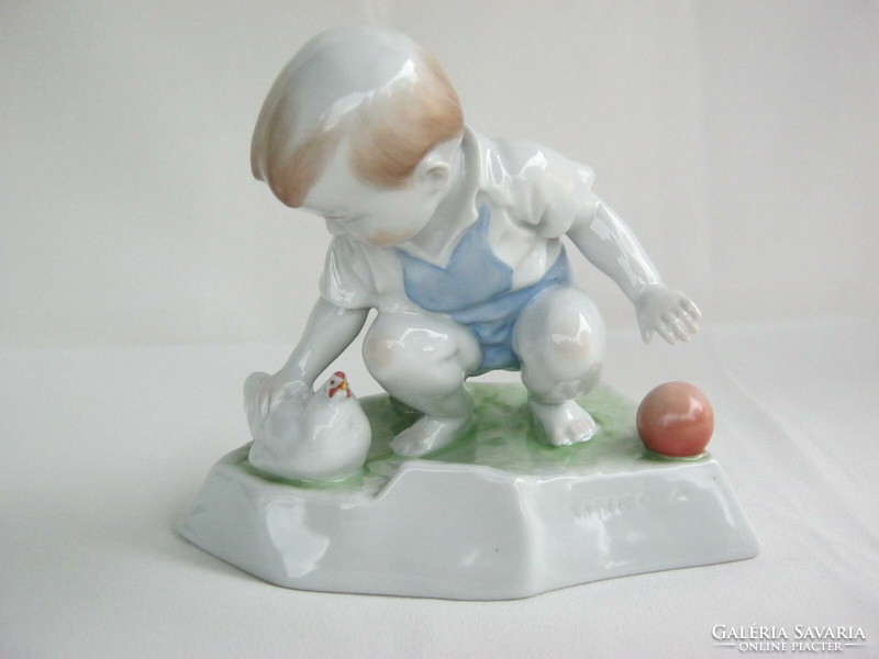 Little boy stroking Zsolnay porcelain hen