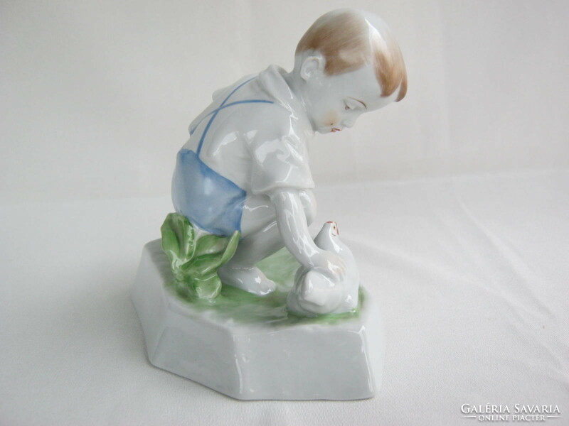 Little boy stroking Zsolnay porcelain hen