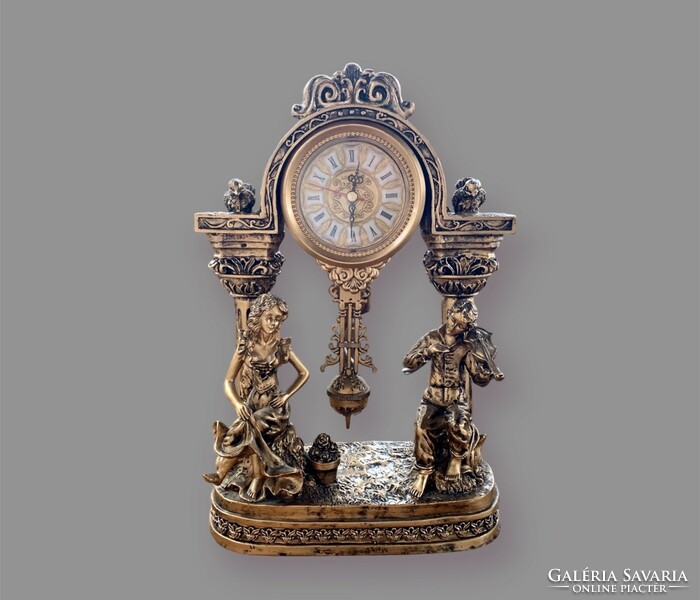 A wonderful Rococo mantel clock. (33 Cm), quartz movement, nearly 2 kg.