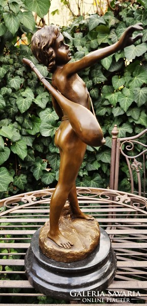 Boy playing music - bronze statue