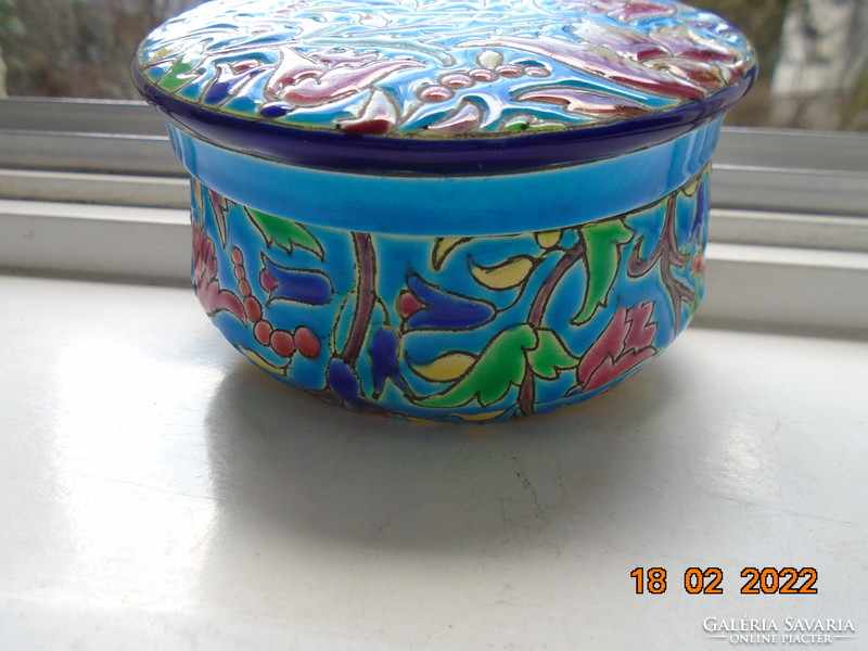 Antique longwy majolica bonbonier embossed with colorful enamel patterns on a turquoise background