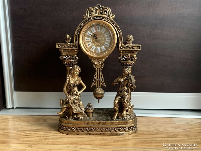 A wonderful Rococo mantel clock. (33 Cm), quartz movement, nearly 2 kg.