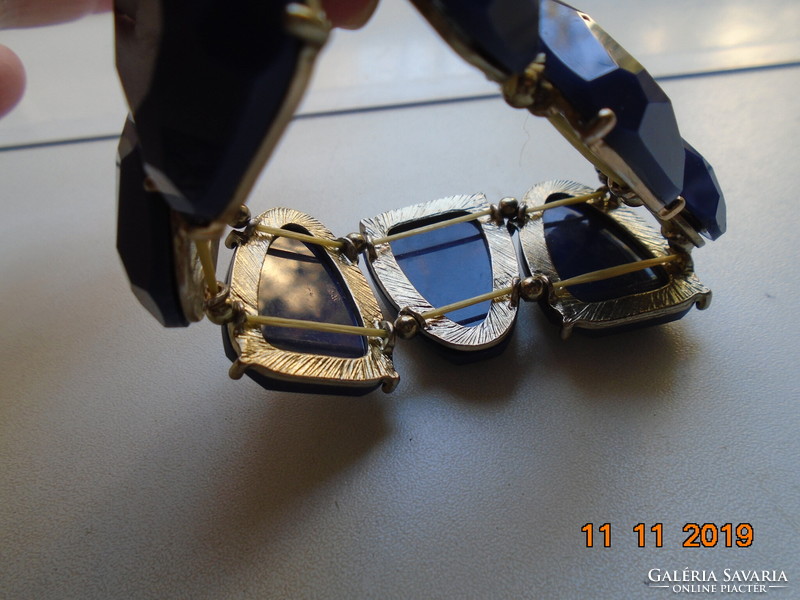 A wide bracelet made of faceted royal blue stones in a silver-plated socket