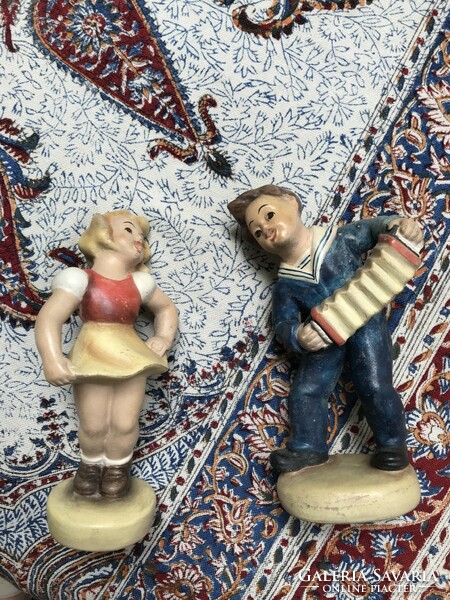 Pair of ceramic figurines dancing girl and boy playing the accordion