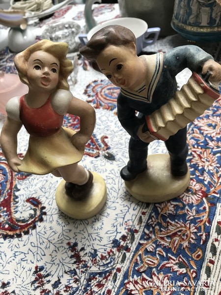 Pair of ceramic figurines dancing girl and boy playing the accordion