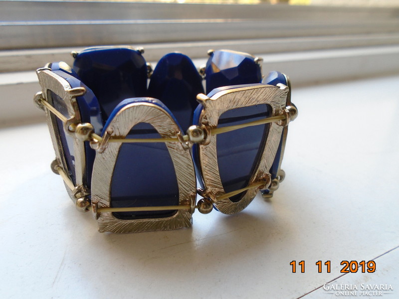 A wide bracelet made of faceted royal blue stones in a silver-plated socket