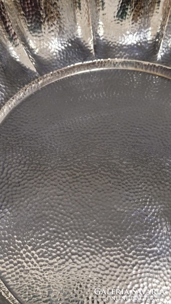 Antique silver serving tray with a hand-hammered pattern