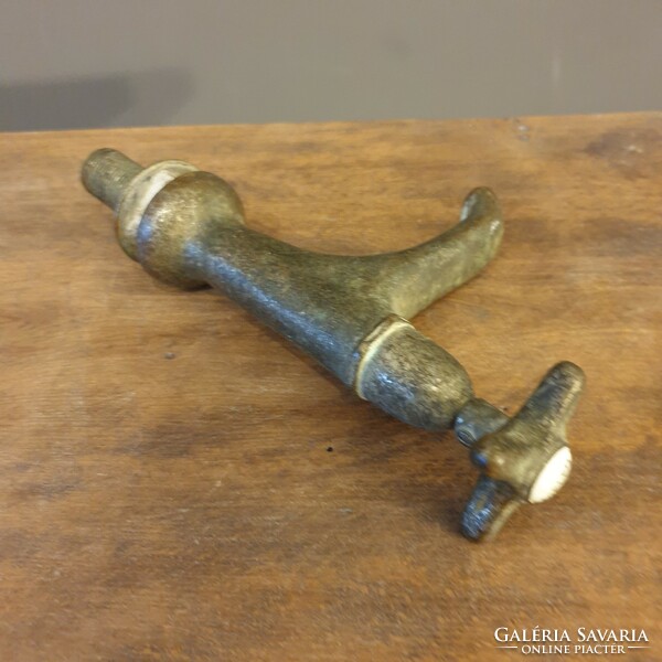 Old thick-walled copper tap with porcelain insert