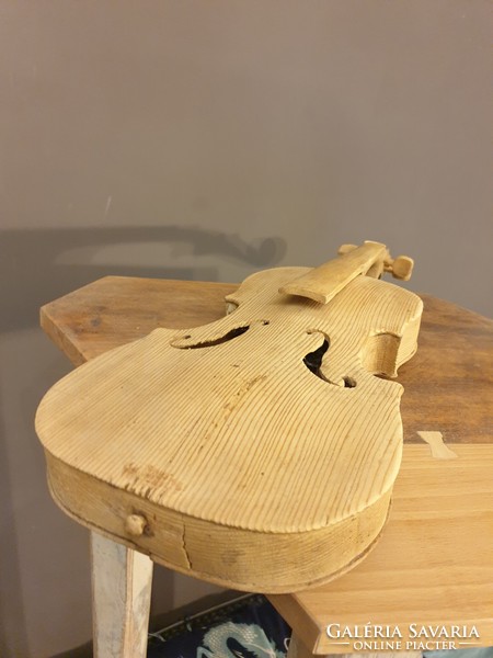 Beautiful carved peasant violin made of natural wood vintage loft decoration shop equipment