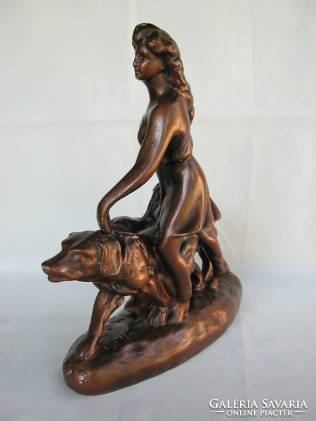 Statue of a woman walking a dog
