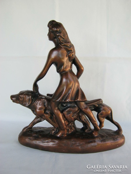 Statue of a woman walking a dog