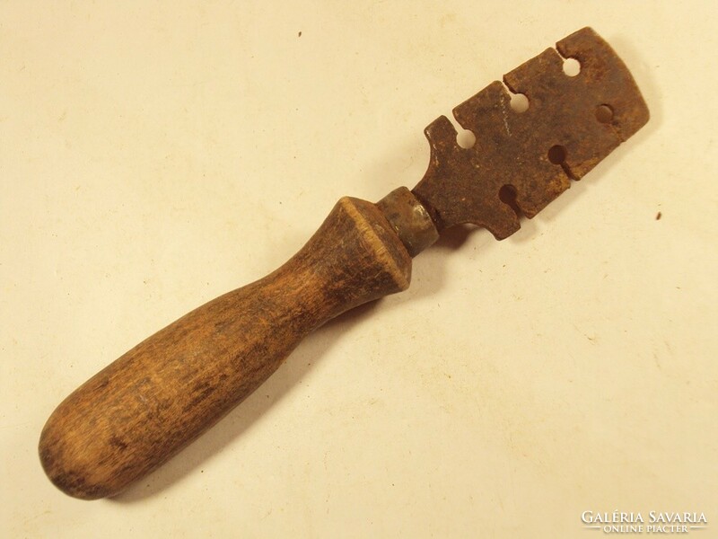 Old saw tooth with folding wooden handle