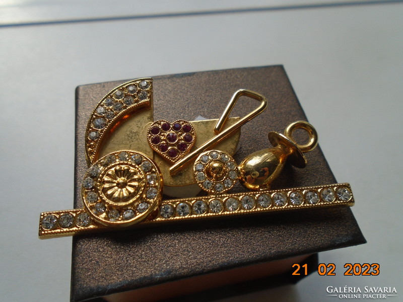 Gold-plated pram brooch with many red and clear cut stones