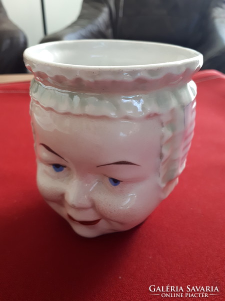 Cup depicting a kid's head, collectible piece