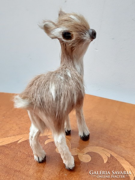 A charming retro deer toy figure covered with real fur