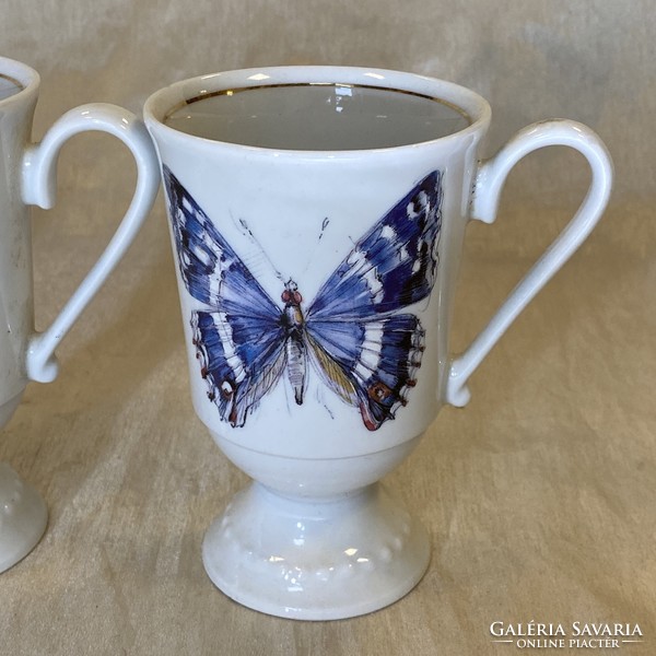 Antique porcelain chocolate cups with a butterfly pattern
