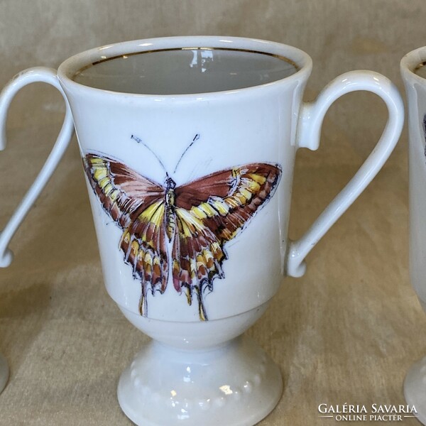 Antique porcelain chocolate cups with a butterfly pattern