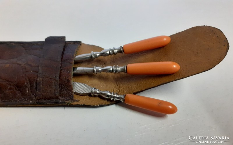 Antique elegant small manicure set with red coral stone handles in a leather case
