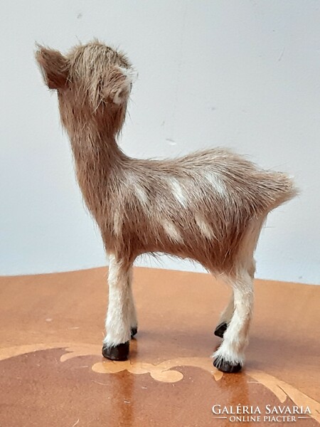 A charming retro deer toy figure covered with real fur