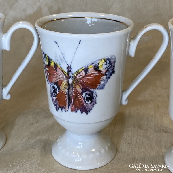 Antique porcelain chocolate cups with a butterfly pattern