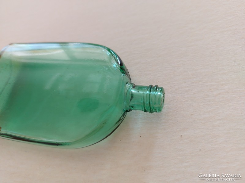 Old perfume bottle in green vintage cologne bottle