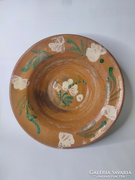 Old hand-painted glazed earthenware wall plate