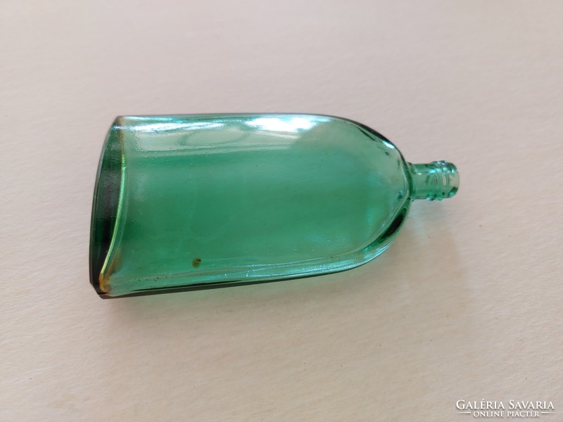 Old perfume bottle in green vintage cologne bottle