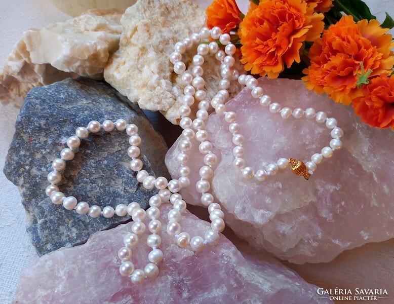 Real room. Long white freshwater pearl necklace made of selected beads, with decorative clasp