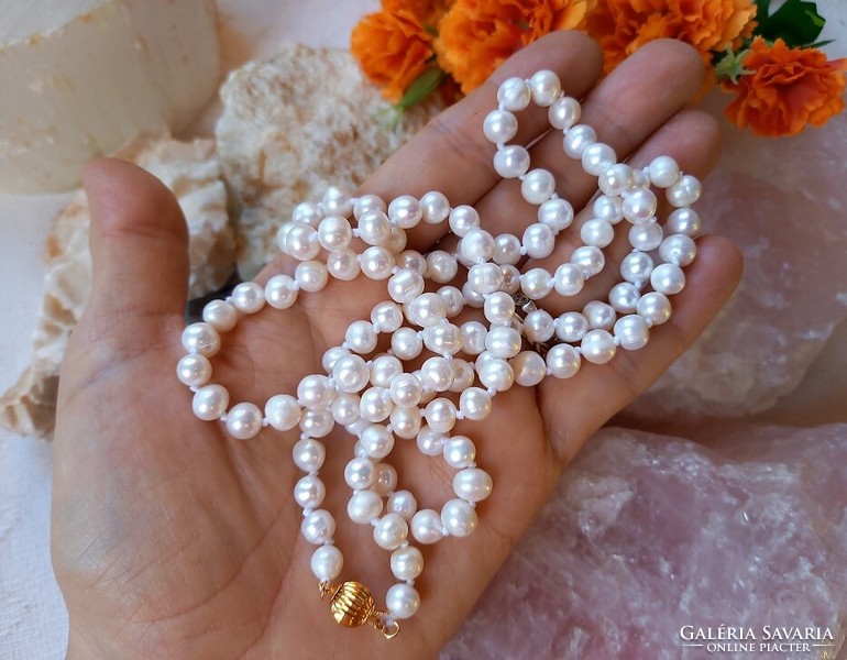 Real room. Long white freshwater pearl necklace made of selected beads, with decorative clasp