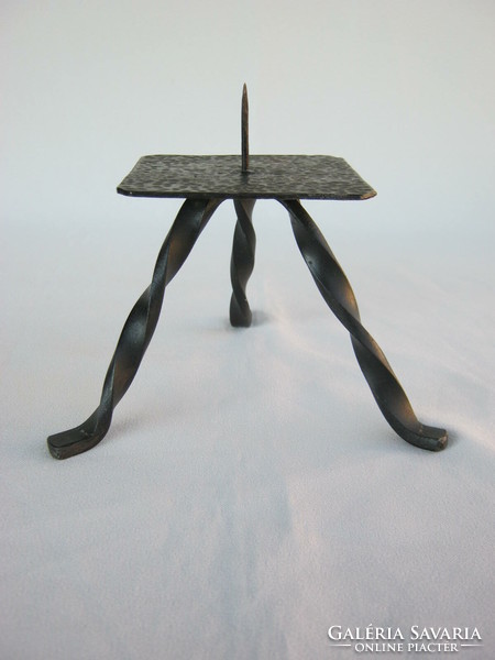 Wrought iron three-legged candlestick