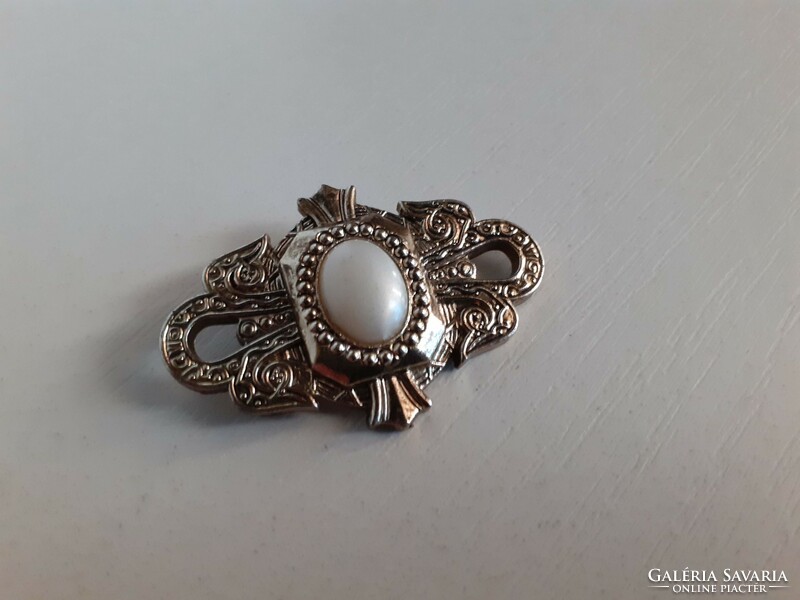 Retro brooch with white stone in the middle