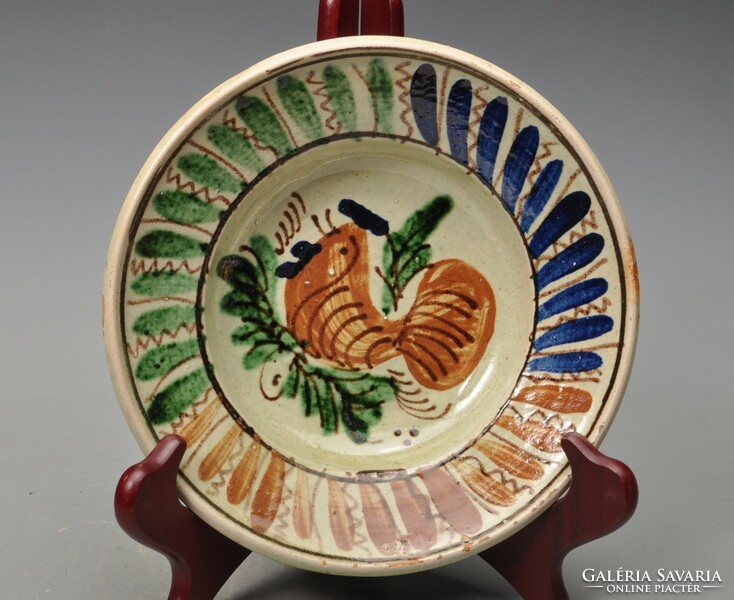 Old Transylvanian earthenware plate with rooster. Symptomatic.