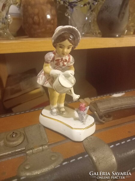 Little girl with watering can, porcelain