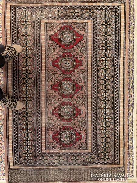 A small, worn Pakistani rug