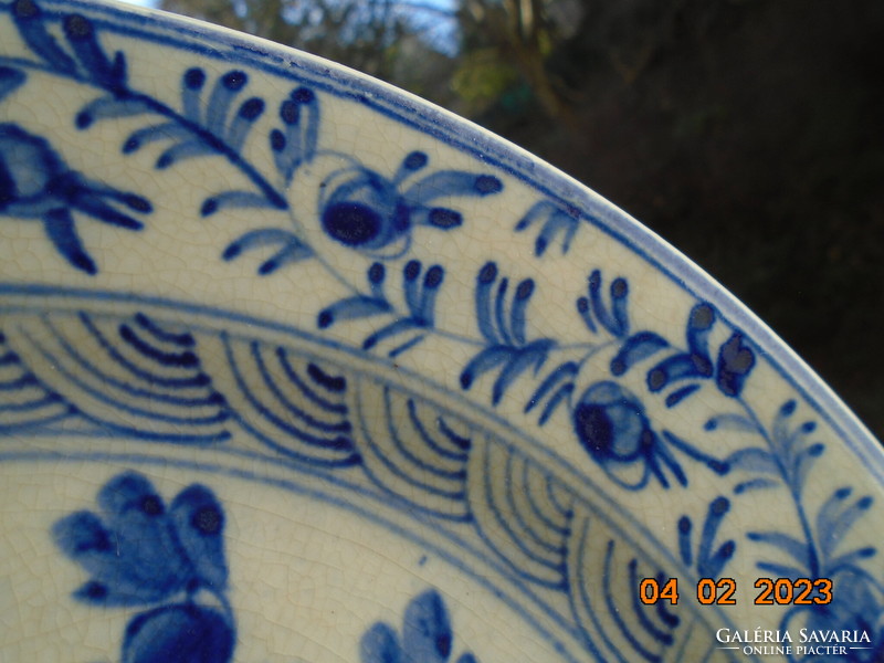 An early Ming Chinese plate with a floral pattern, hand-painted with cobalt blue under an antique glaze