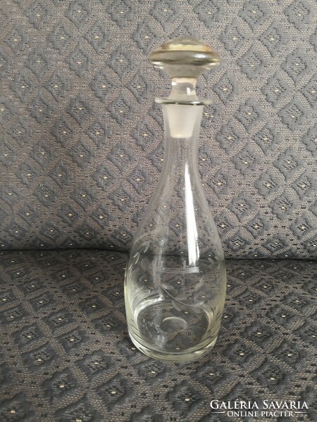 Torn, engraved, vintage glass bottle with stopper