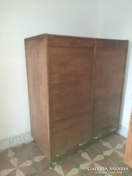 A cabinet with shuttered drawers and index cards