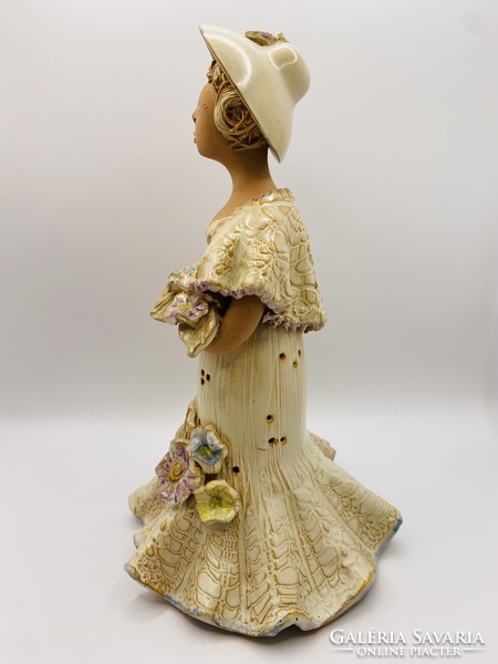 Marked ceramic woman figure with a bouquet of flowers