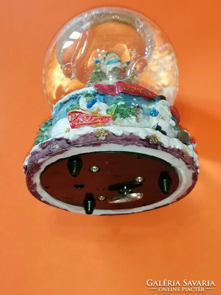 Large, mechanical Christmas snow globe with musical structure.