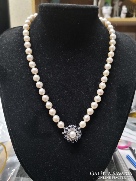 Beautiful string of pearls with 14k white gold clasp, sapphire and diamond inlay