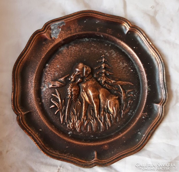 Old bronze wall plate with a hunting scene