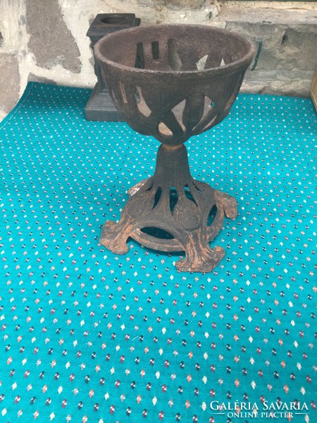 An iron holder in the shape of a chalice, perhaps a church church or peteoleum lamp