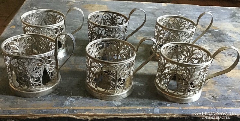 Set of tea and coffee cup holders made of openwork metal