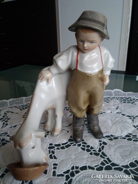 Zsolnay's boy feeding a goat with a shield seal, stamped with a mold number from 1922.