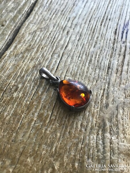Old silver pendant with amber stone
