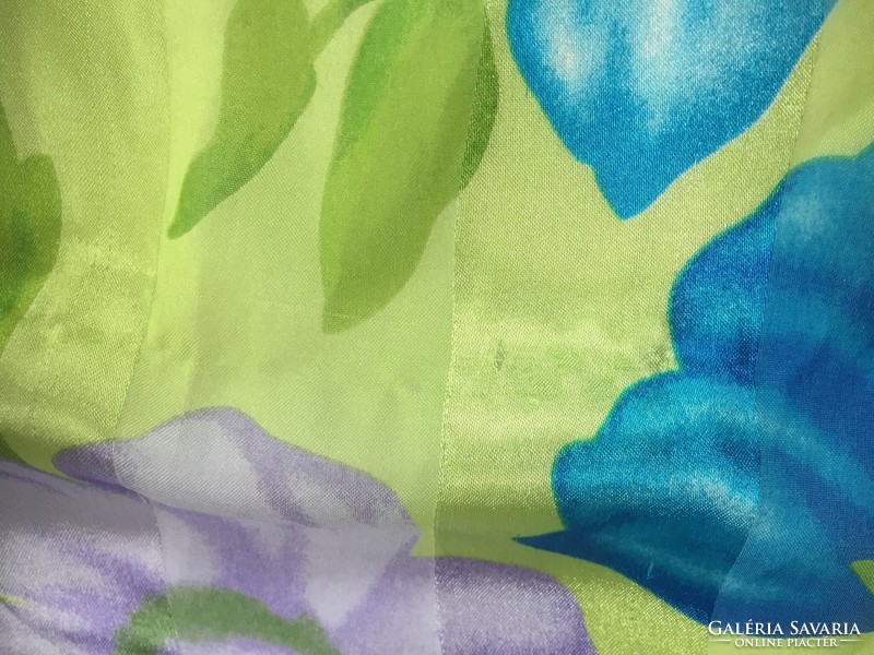 A young, brightly colored floral print scarf with a silky sheen