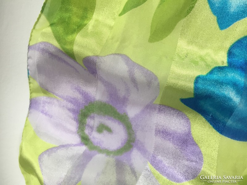 A young, brightly colored floral print scarf with a silky sheen