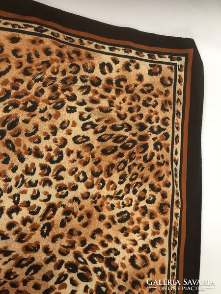 A playful little scarf with a pattern similar to an Ocelot pattern, with sand and black colors