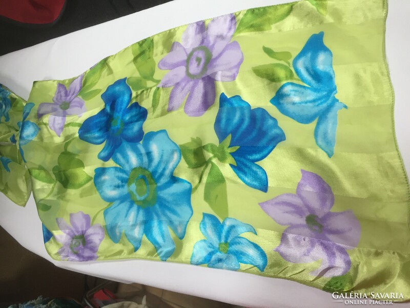 A young, brightly colored floral print scarf with a silky sheen